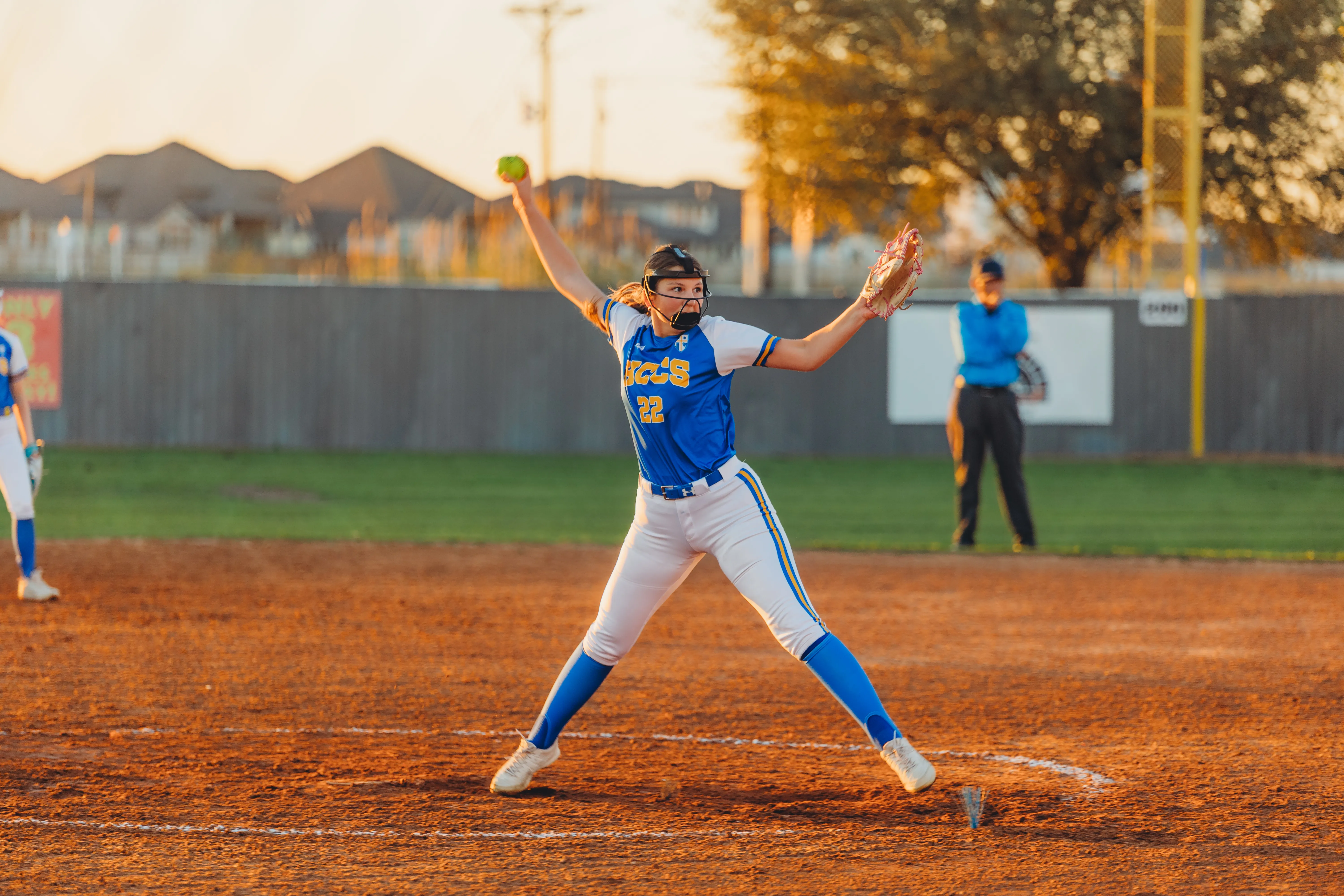 A Rams softball pitcher mid-windup