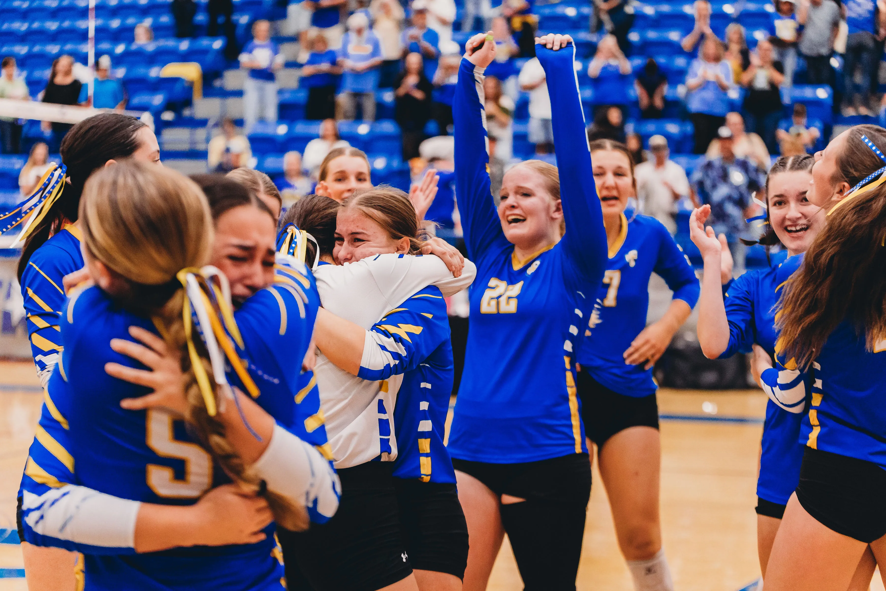 Rams volleyball players celebrating together after a win