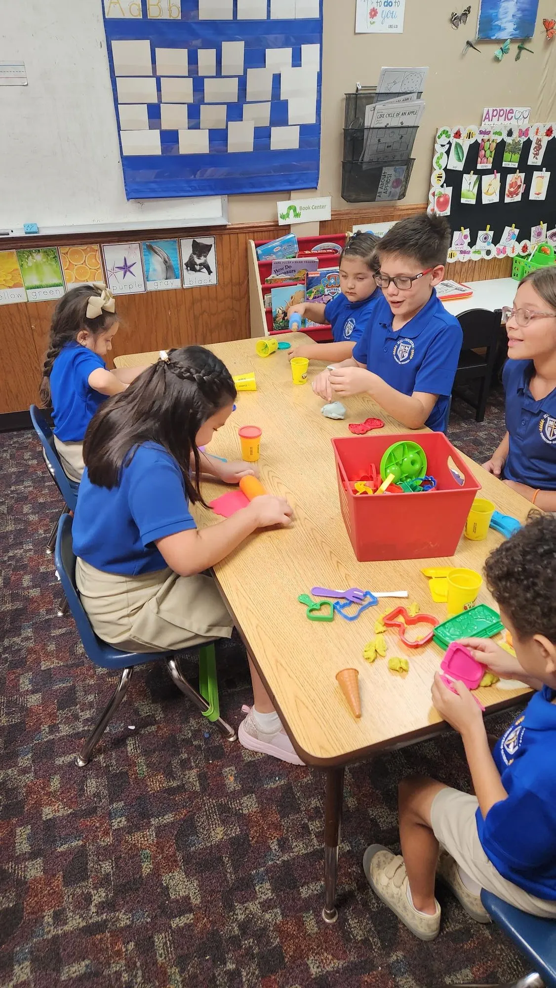HCCS students working together on a project at a classroom table