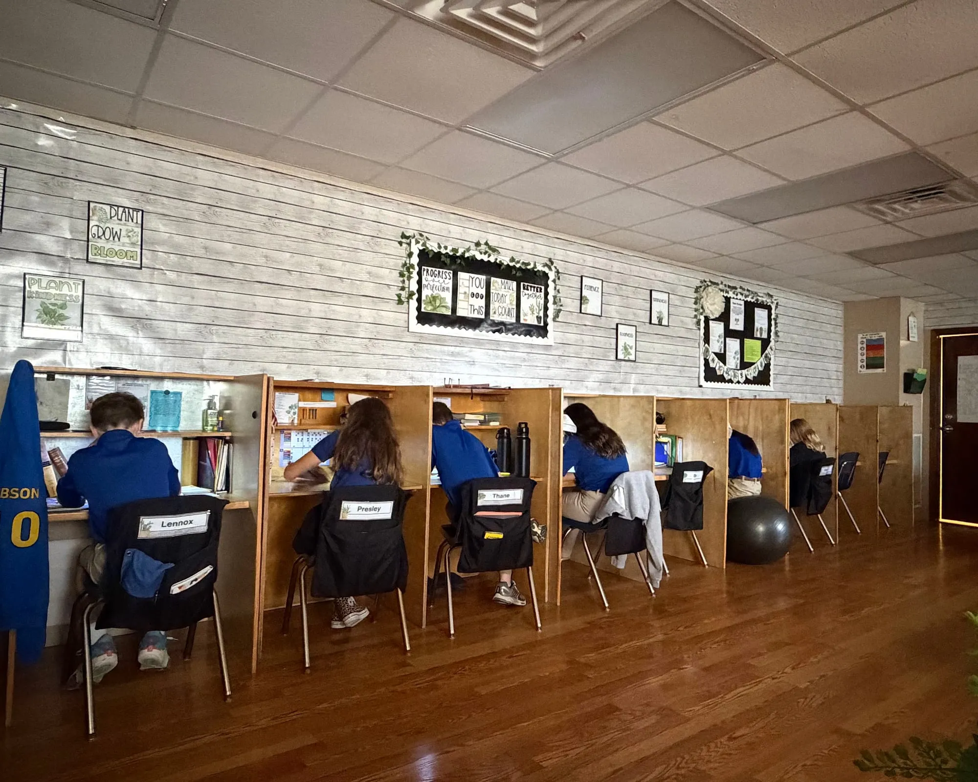 HCCS students working at their individual learning offices, each carrel set up for one student