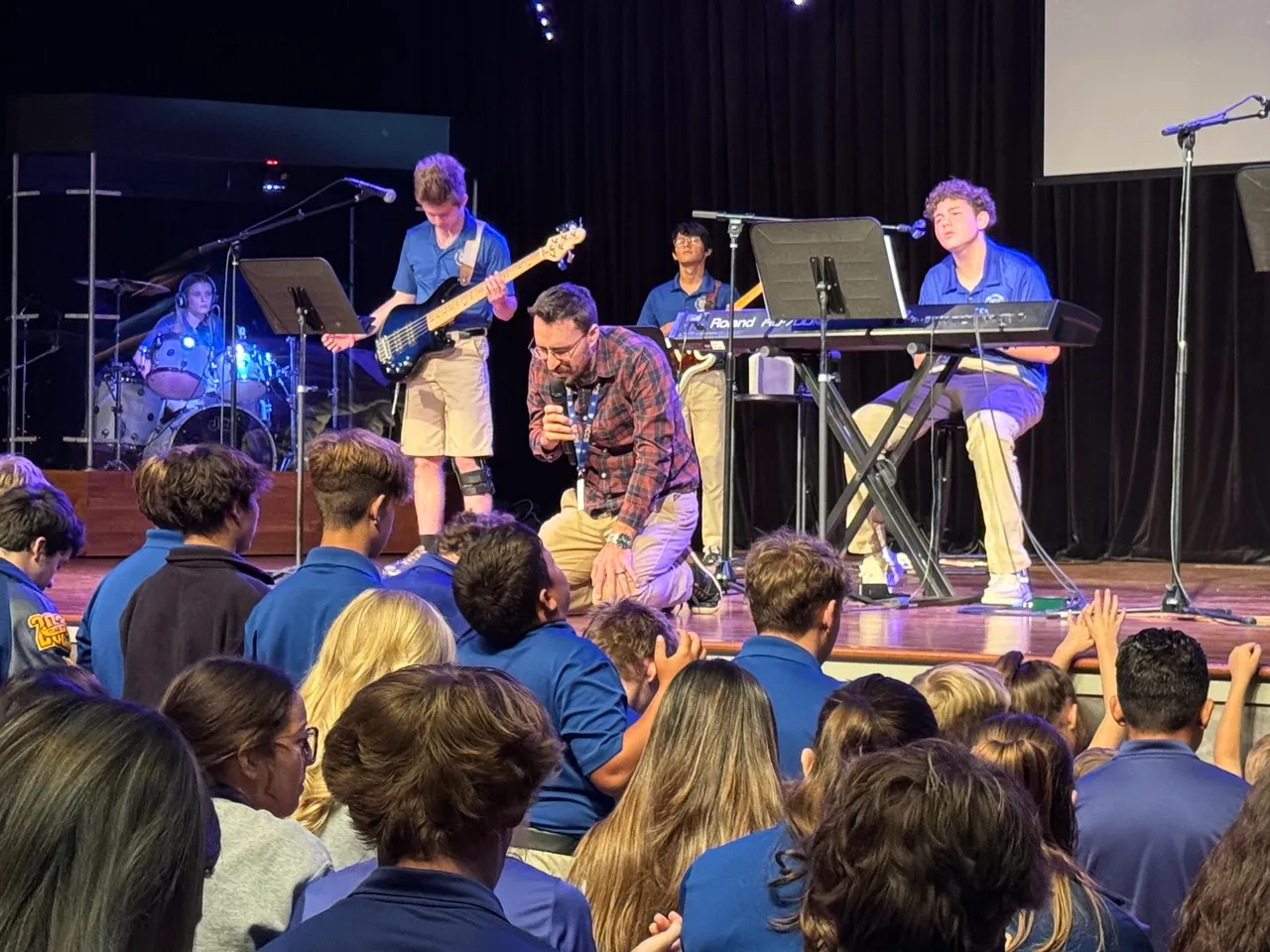 HCCS students and the chapel band worshipping together during chapel