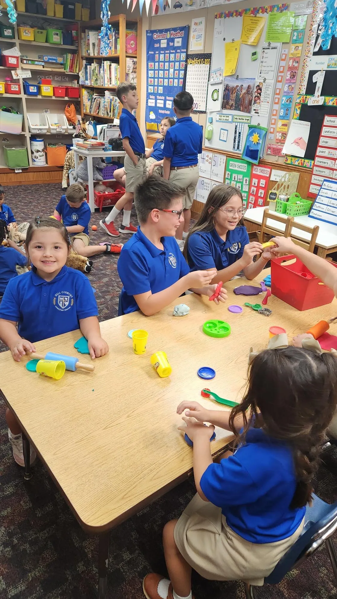 Elementary students crafting together at a classroom table